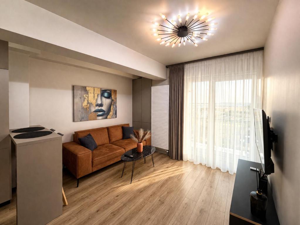 a living room with a couch and a window at Fly & Stay Otopeni Airport - Self Check-in in Otopeni