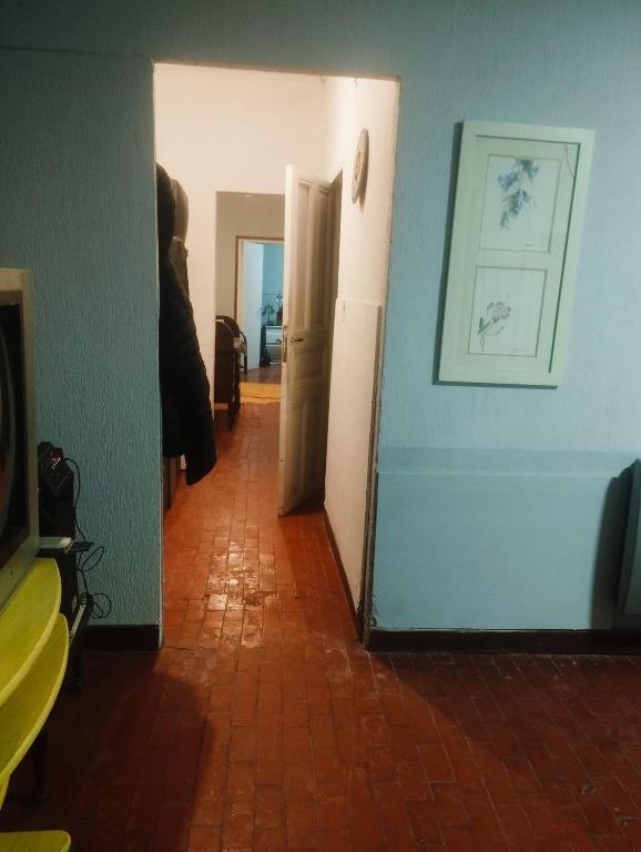 a hallway with a white refrigerator and a door at Martin House in Chascomús