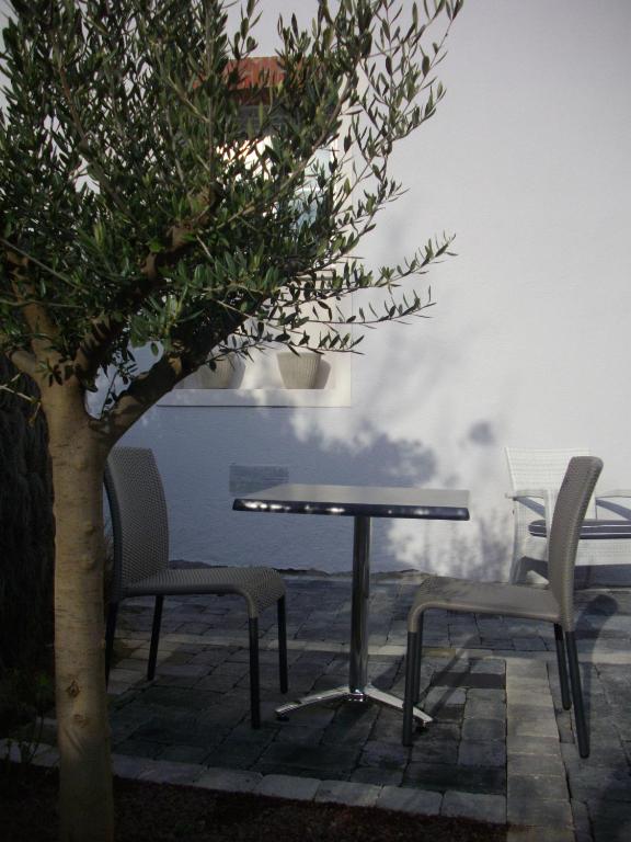 a table and two chairs next to a tree at Hotel Mona Lisa in La Baule
