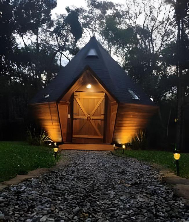 a barn with a large wooden door on a driveway at Diamond Cabin in the Forest | Hot Tub | AC | Fire Pit in Gonçalves