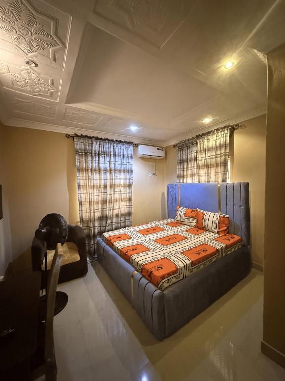 a bedroom with a blue bed in a room at CEO Da Gracia Hotel, Irewon, Ijebu Ode in Ijebu Ode