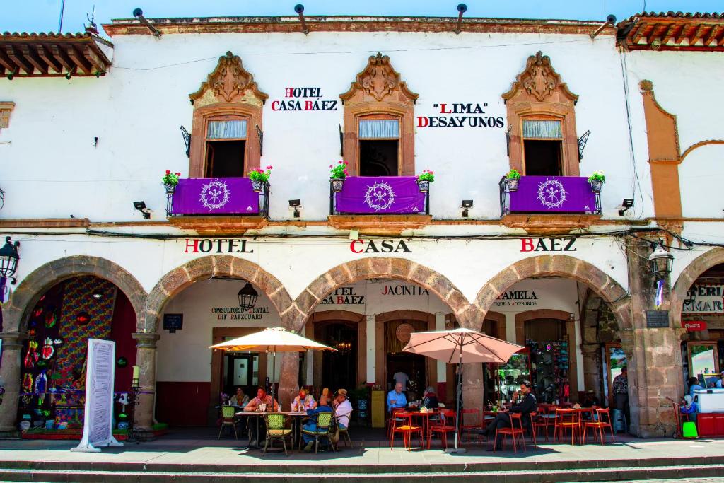 people sitting at tables outside of a building at HOTEL CASA BAEZ in Pátzcuaro