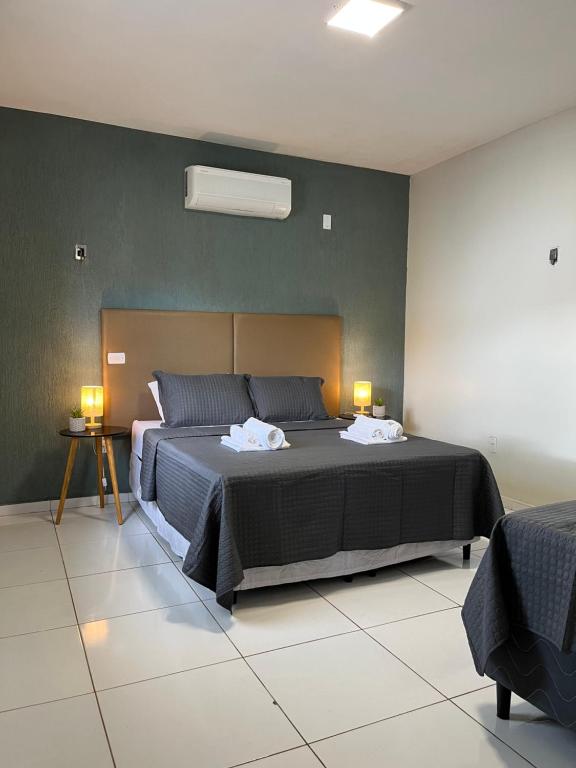 a bedroom with a bed with two pillows on it at Apto Master a 30m da Praça da Sé - Norões Residence in Crato