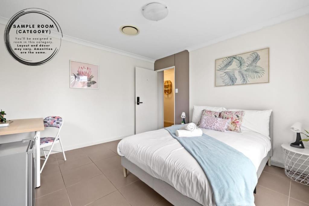 a bedroom with a bed and a desk and a table at Cozy Double Room in Panania - Close to Stations & Stores - Shared Bathroom in Panania