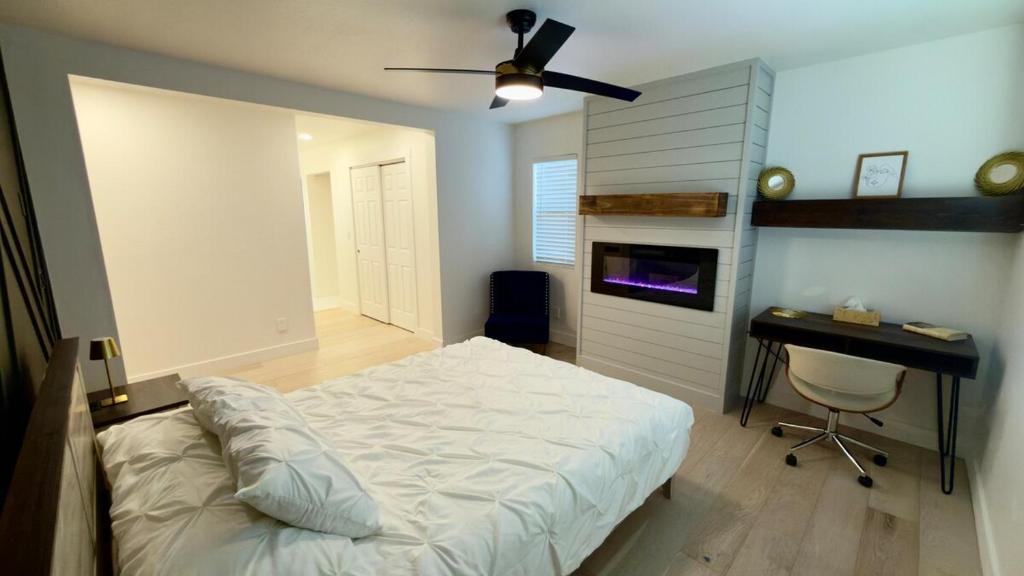a bedroom with a bed and a desk and a ceiling fan at Modern Luxury Haven in Colorado Springs