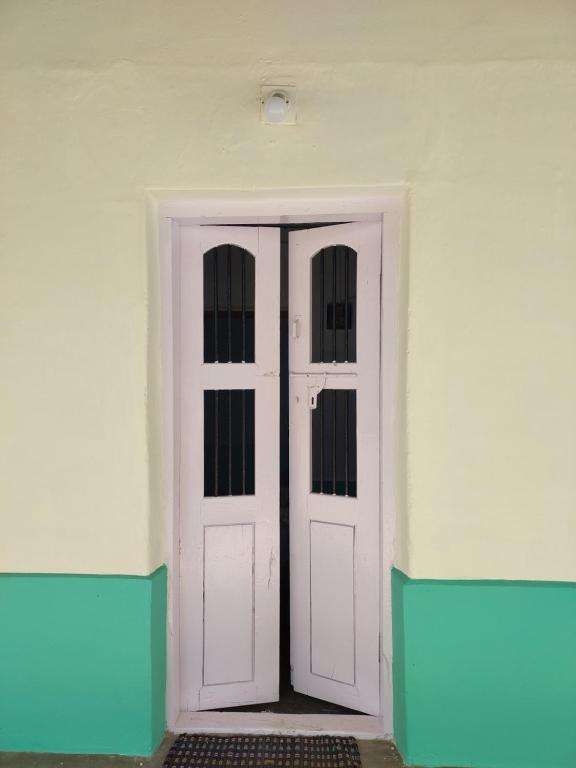 a white door in a room with a white wall at Alumpara House - Home Stay in Palakkad