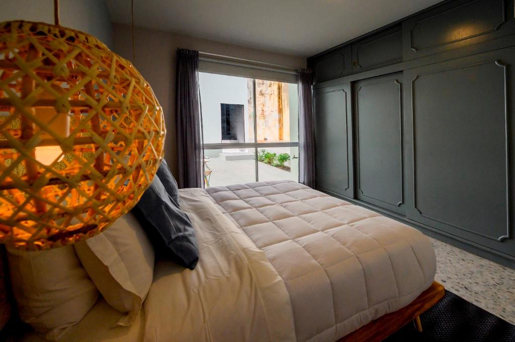 a bedroom with a large bed and a large window at MATAMOROS 2 · Refugio Céntrico con Piscina in Oaxaca City