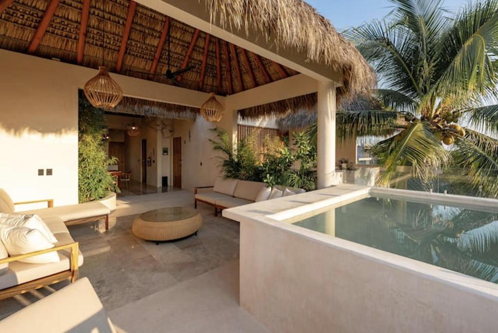 a patio with a swimming pool and a resort at PH POINTE · Luxury Penthouse with Pool in Brisas de Zicatela