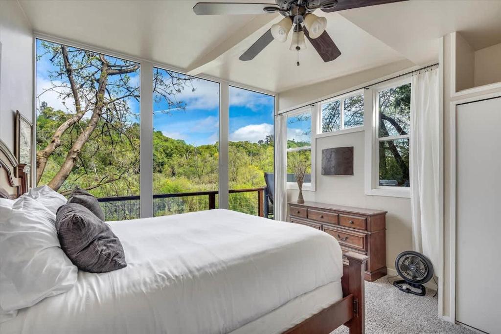 a bedroom with a bed and a large window at River View Lodge - Hot Tub And Tastings Included in Healdsburg