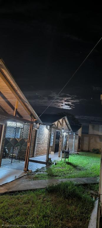 a building with a roof with a bench in a yard at Departamentos Hernan in Apóstoles