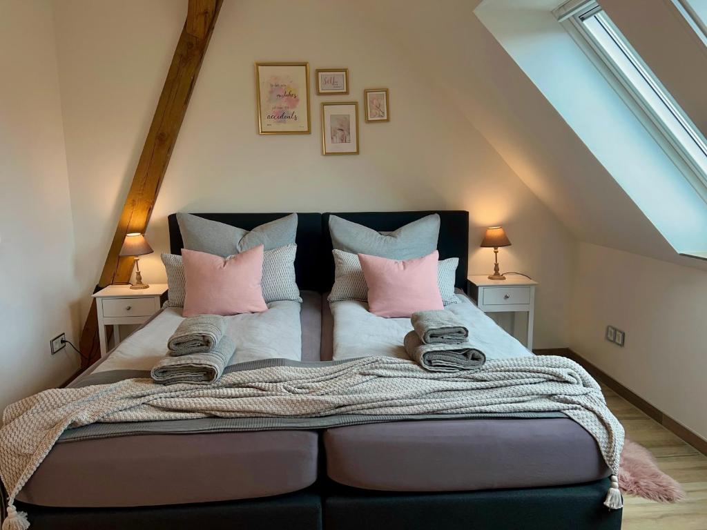 a bedroom with a large bed with pink pillows at INTERGO Apartments in Brackel