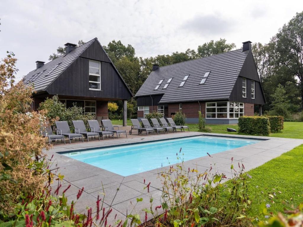 a house with a swimming pool in the yard at Achterhoek Villa with Heated Pool in Aalten