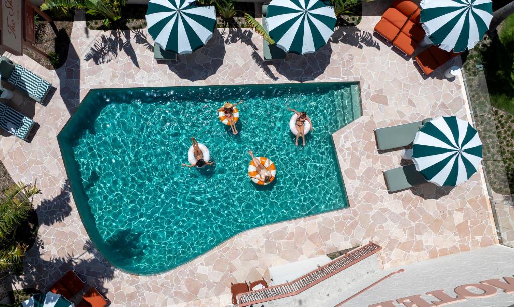 an overhead view of a swimming pool with people in the water at The Shores Miami in Gold Coast