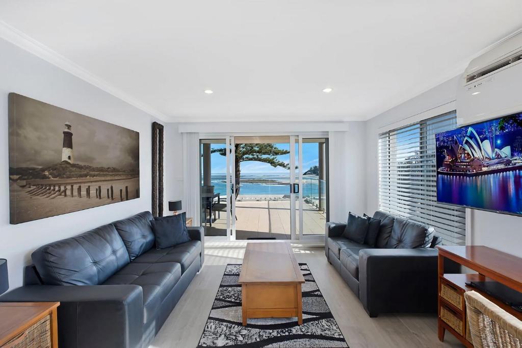 a living room with a couch and a table at Ocean Pines Apartments 4 in The Entrance