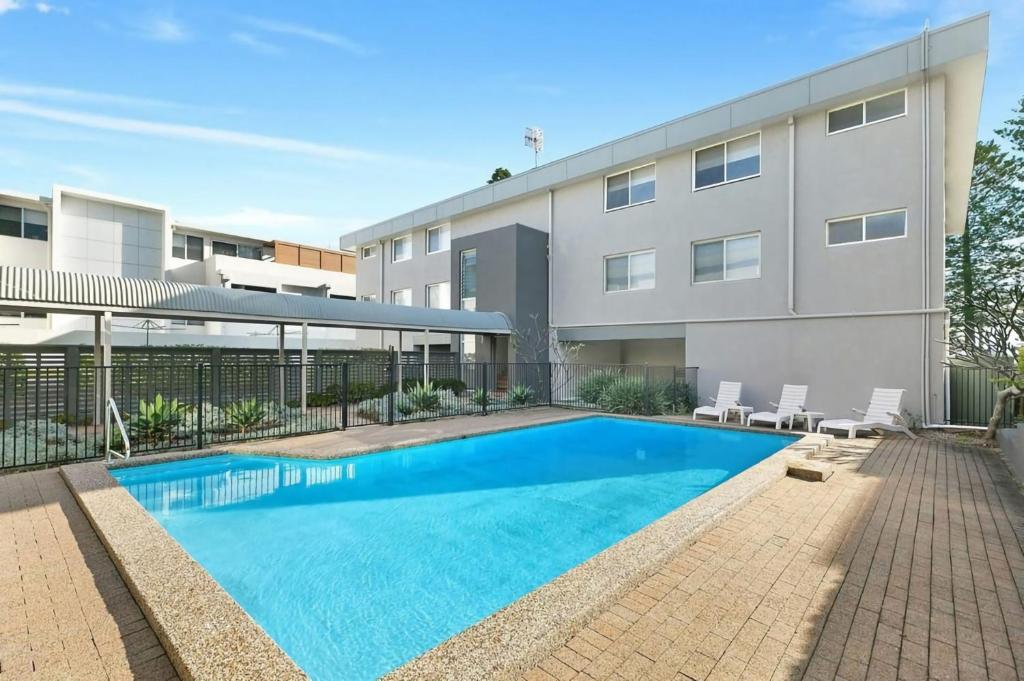 an image of a swimming pool in front of a building at Regency Court 4 in The Entrance