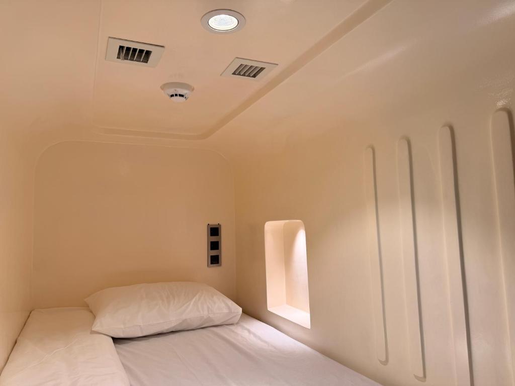 a bedroom with a white bed and a window at Factor Inn - Old Quarter Centre in Hanoi