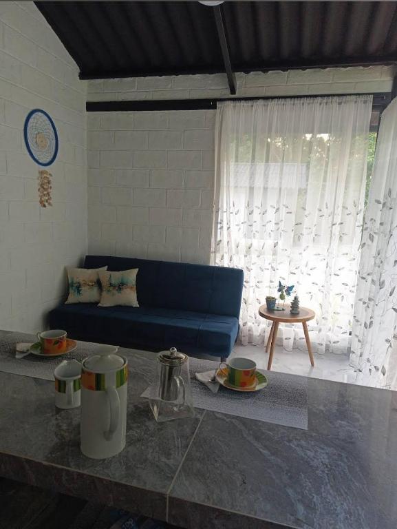 a living room with a blue couch and a table at El Eden in Santa Elena