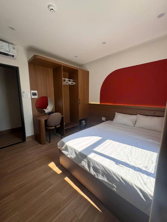 a bedroom with a large bed and a desk at Airport Homestay 2 in Danang