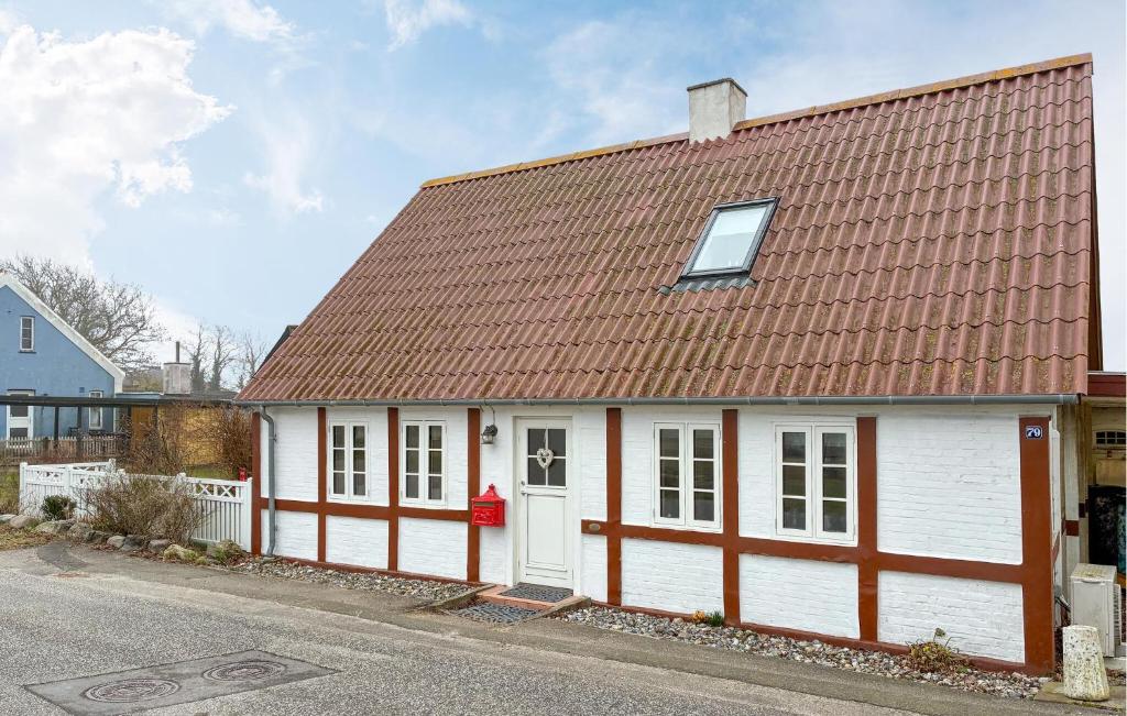 a white and red house with a brown roof at 2 Bedroom Nice Home In Gedser in Gedser
