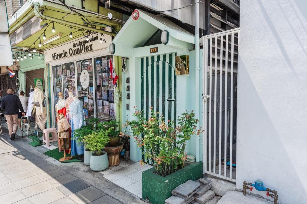 a store on a street with people walking in front of it at An Ant House in Bangkok