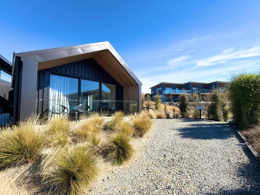 a house with a glass facade and some plants at The Quarters Unit 2 - Lake Tekapo in Lake Tekapo