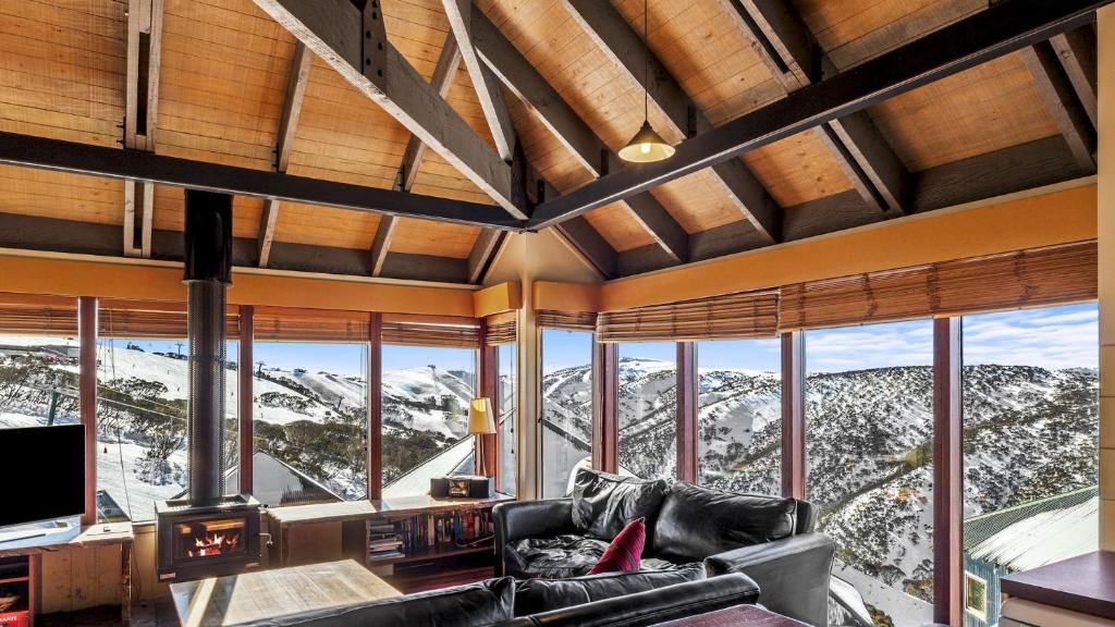 a living room with a view of mountains at Gundanora Chalet in Mount Hotham