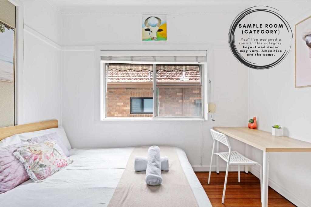 a small bedroom with a bed and a desk at Private Double Room - Centrally Located At Ryde - Shared Bathroom in Sydney