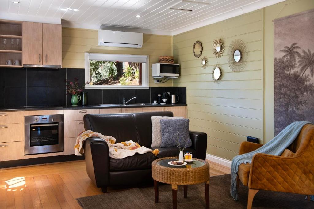 a living room with a couch and a table at Avalon in Hepburn Springs