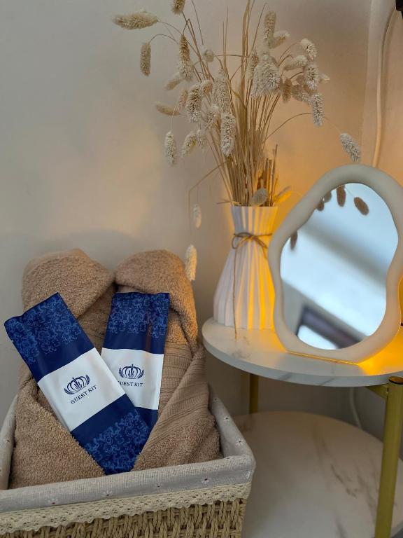 a mirror sitting next to a table with towels at MGs Dwell - Baguio Transient at Moldex Residences in Baguio