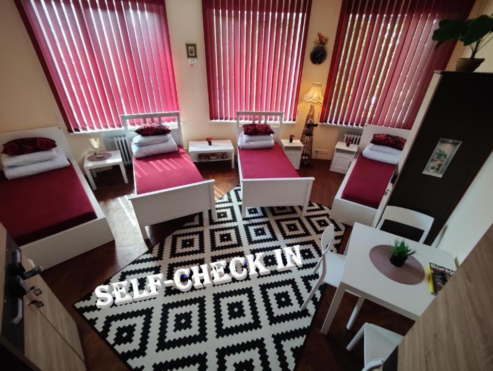 an aerial view of a living room with red windows at Central at Kaunas Hostel in Kaunas