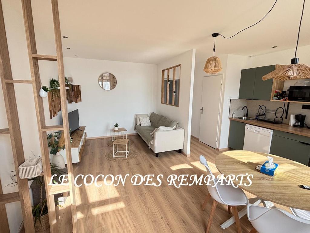 a view of the living room and kitchen of a apartment at Le Cocon des Remparts in Gravelines
