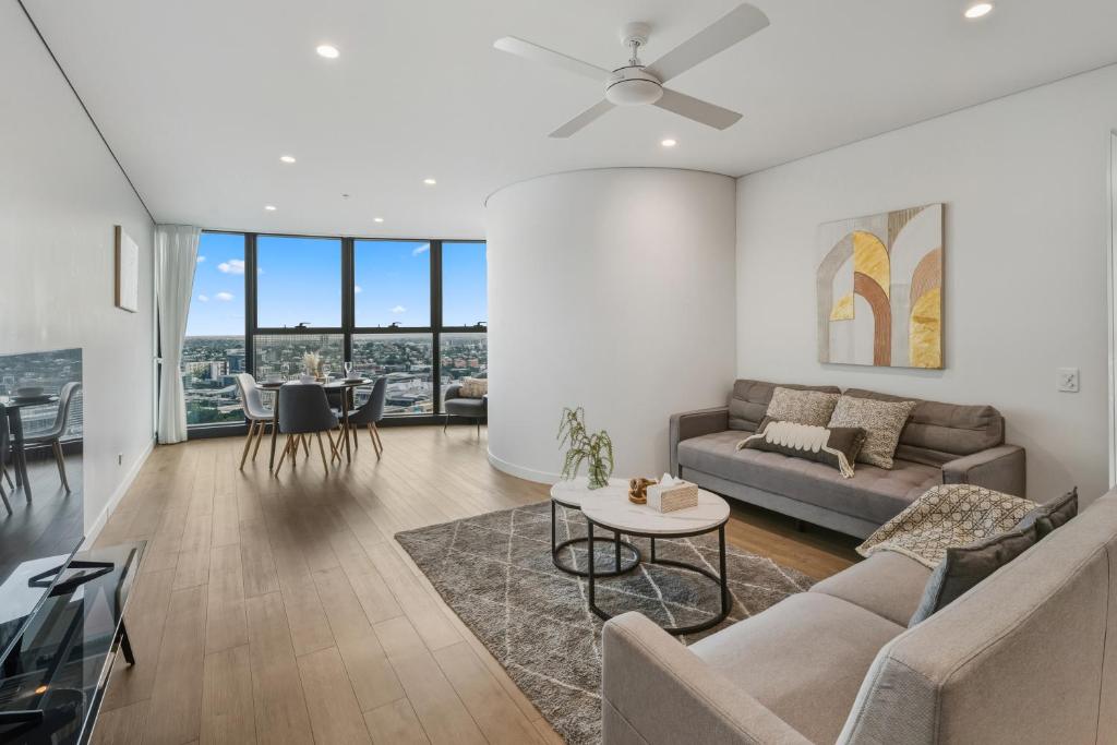 a living room with a couch and a table at 2B2B High Floor Apt with RiverView & Parking in Brisbane