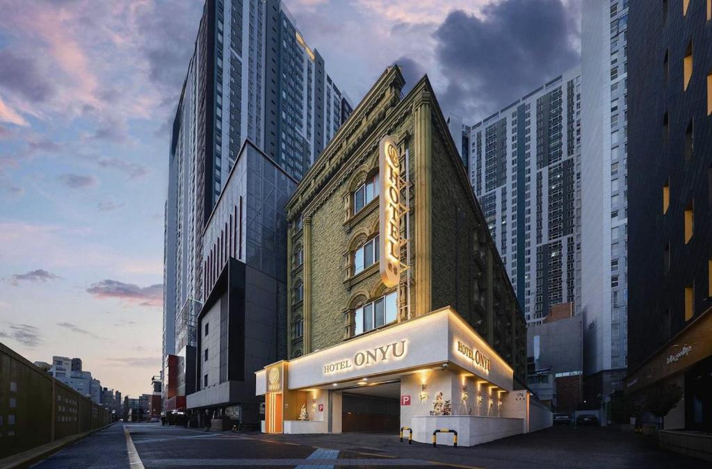 a building with a sign on the side of it at Hotel ONYU Busan Sasang in Busan