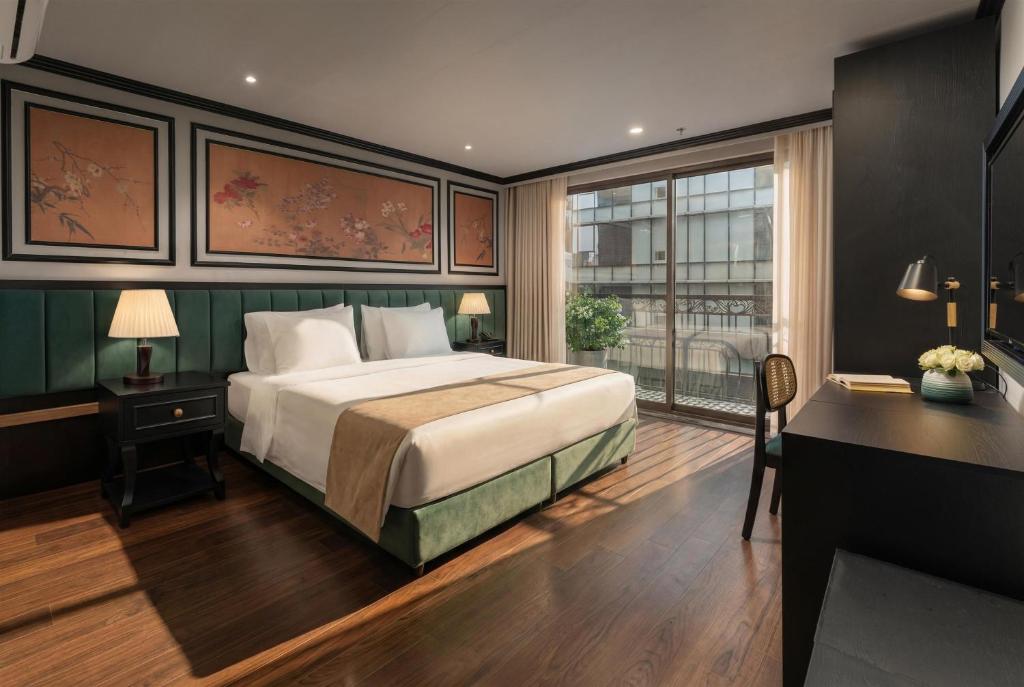 a bedroom with a bed and a desk and a window at Embrace Boutique Hanoi Hotel in Hanoi