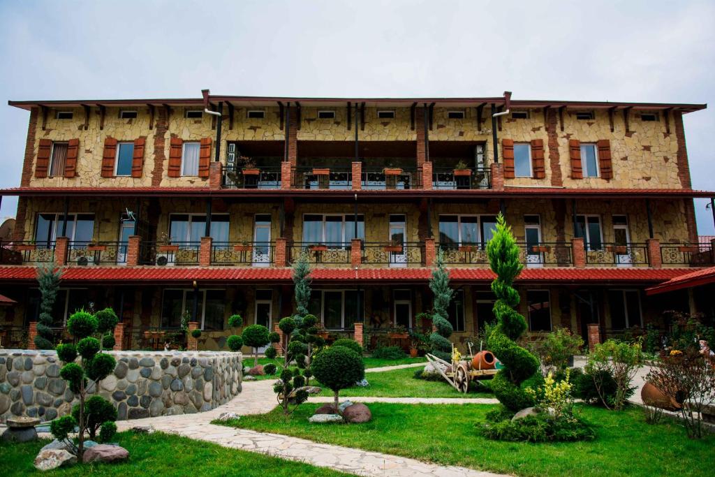 a large building with a garden in front of it at Zedazeni Hotel in Mtskheta