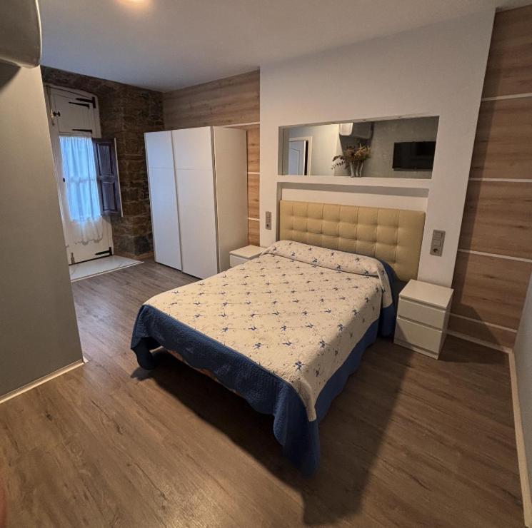 a bedroom with a large bed in a room at Hostal San Juan Oyarbide Tolosa in Tolosa