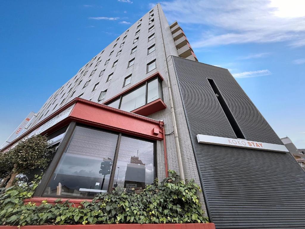 a building with a sign on the side of it at KOKO STAY Sagamihara in Sagamihara