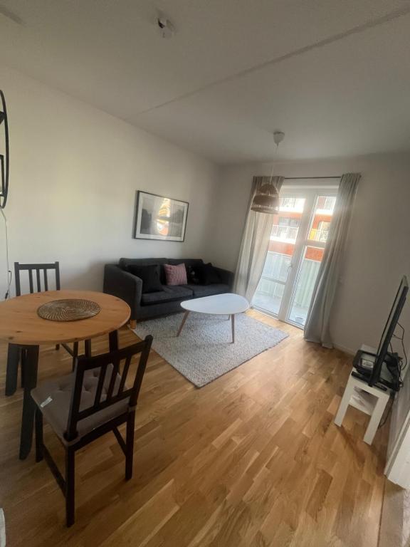 a living room with a table and a couch at Nice flat in Barkarby in Järfälla