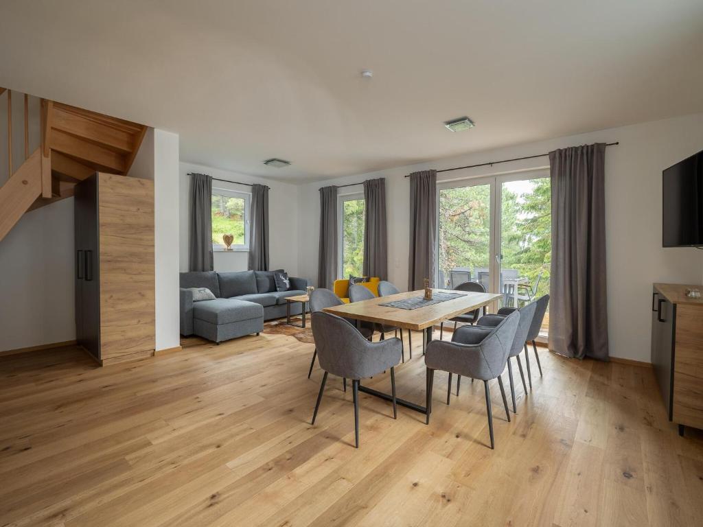 a dining room and living room with a table and chairs at Chalet in Turracher Höhe with Ski Slope Access in Turracher Hohe