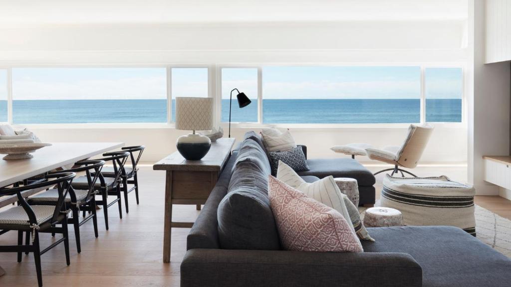 a living room with a couch and a table at The Palms in Palm Beach