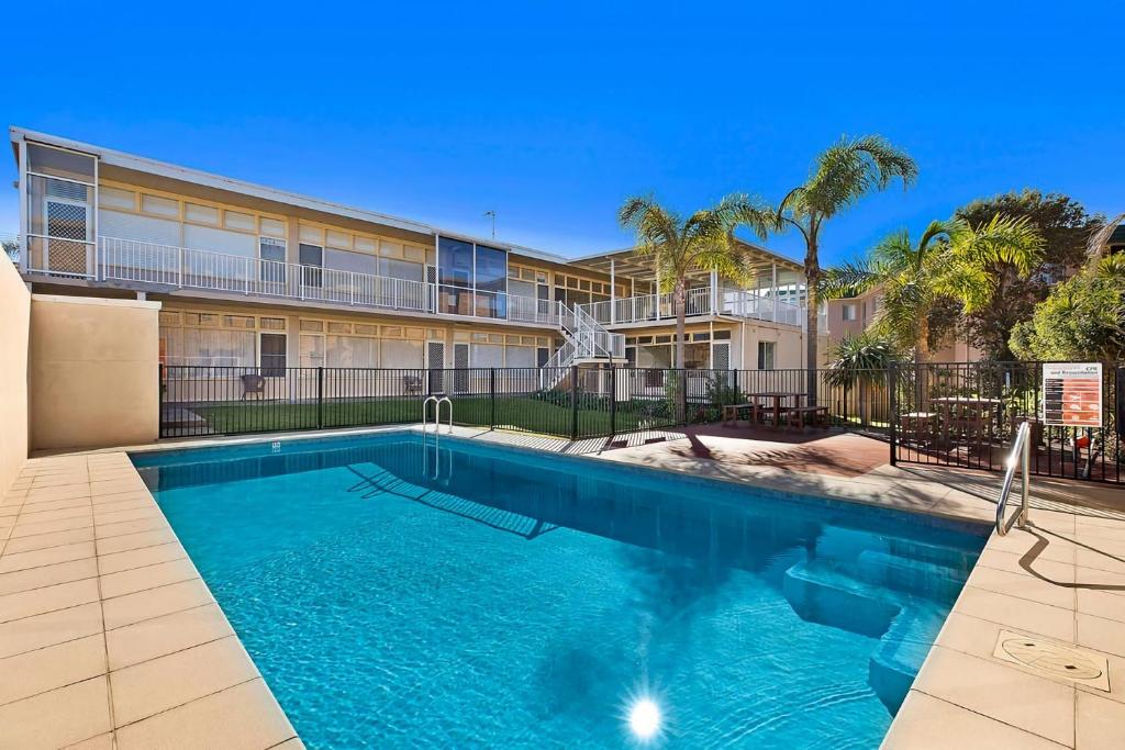 a swimming pool in front of a building at The Sands Apartment 6 in The Entrance