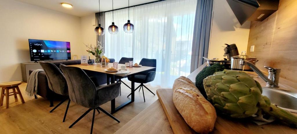 a kitchen and dining room with a table and a sink at Obermain Living in Bad Staffelstein
