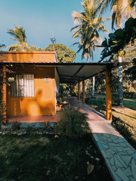 a small house with an orange roof at La Casita Puerto Arista in Puerto Arista