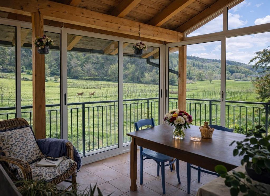a screened in porch with a table and chairs at Noi - Casa vacanza in Attimis
