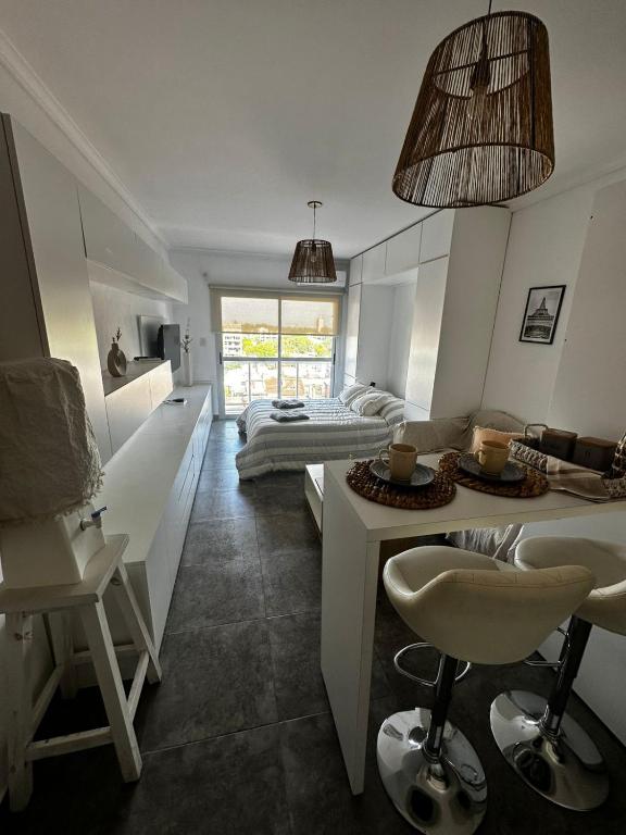 a bedroom with a bed and a table and chairs at Vista Haus in General Sarmiento