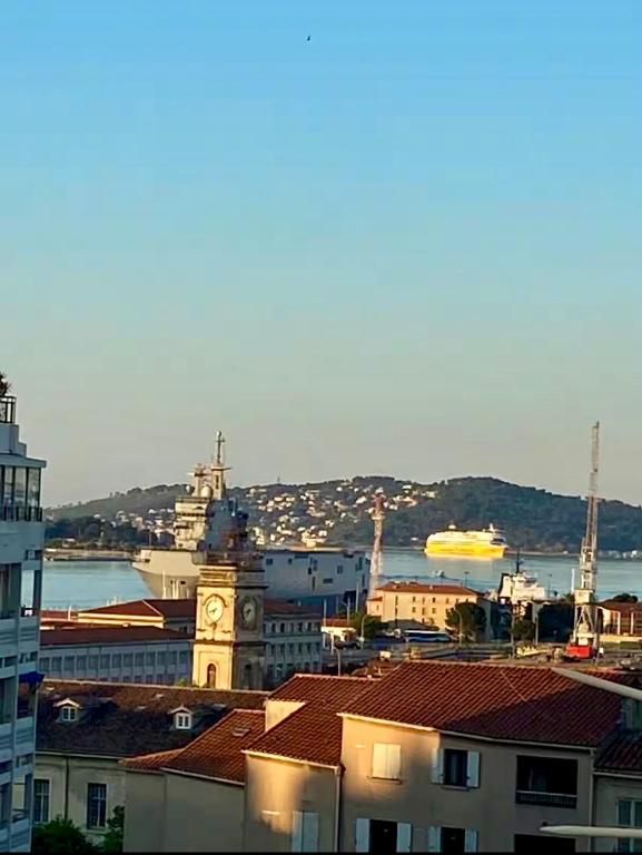 a view of a city with a clock tower at Les Terrasses, charme et authenticité en Hyper Centre de TOULON, Idéal pour un séjour romantique ou une escapade urbaine in Toulon