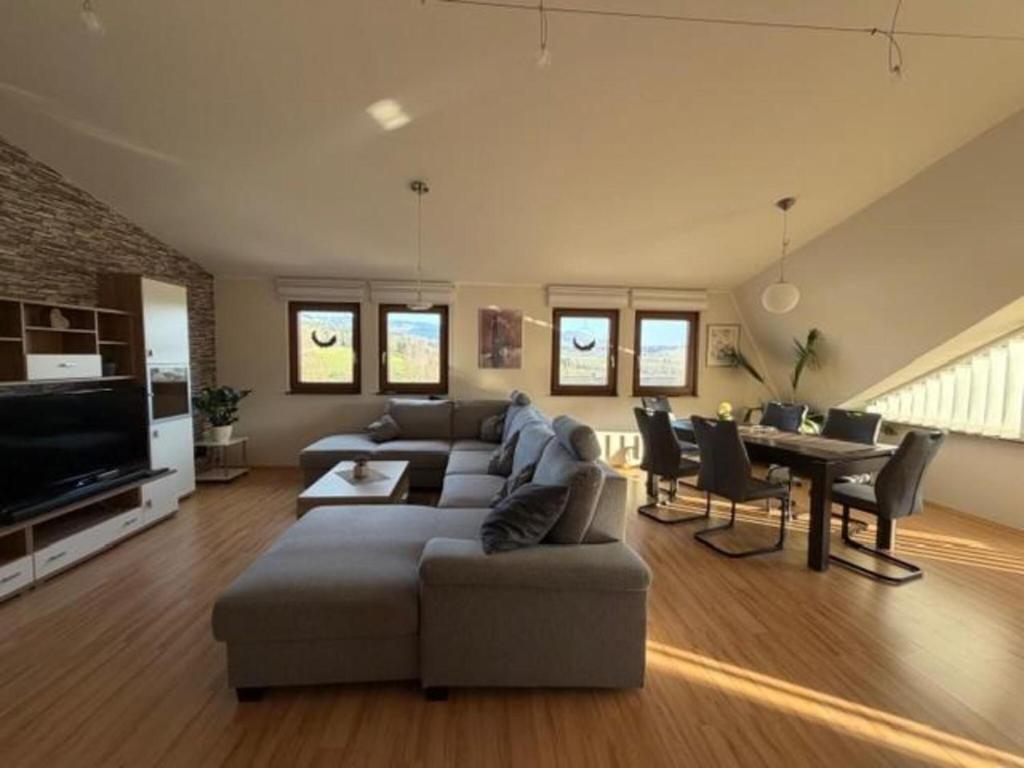 a living room with a couch and a table at Rauschelbach Loft 9 in Poppenhausen