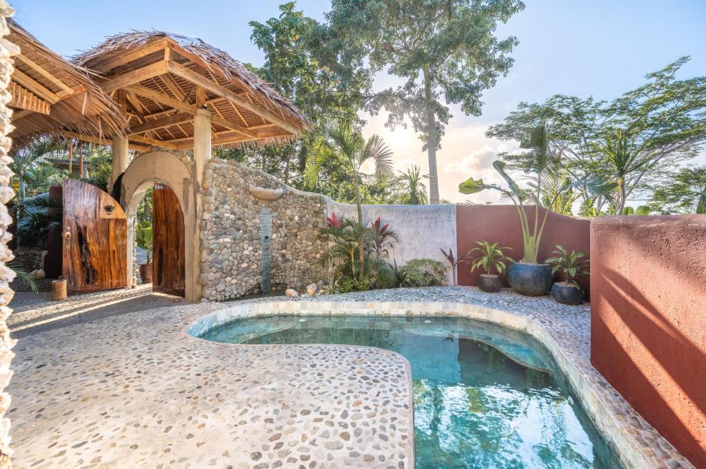 a swimming pool in a backyard with a house at Highlife Hill Villa in General Luna