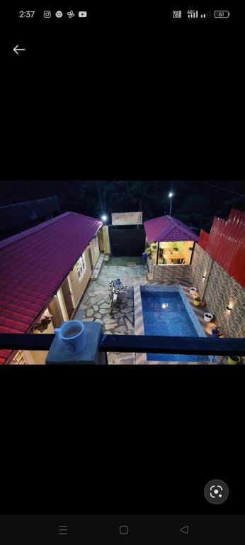 an overhead view of a swimming pool at night at Shivay Hotel & Resort in Dhārchula
