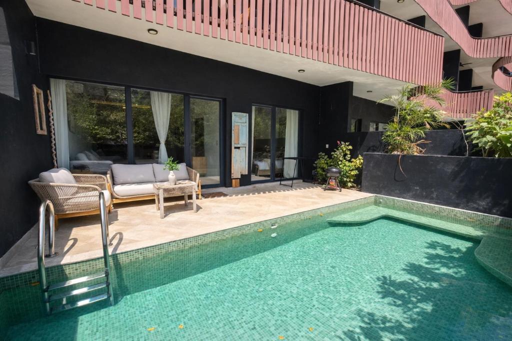 a house with a swimming pool in the backyard at Private Pool with Beach Access and Baby Crib - Tulum Hotel Zone in Tulum